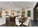 Open kitchen concept features a dining area, central island with barstool seating, and stainless steel appliances at 3773 Randall Se Rd, Atlanta, GA 30339