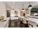 Bright kitchen featuring a large island with marble countertops, stainless steel appliances, and dark hardwood floors at 3773 Randall Se Rd, Atlanta, GA 30339