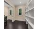 A modern laundry room with custom shelving and a stainless steel washer and dryer at 3773 Randall Se Rd, Atlanta, GA 30339