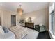 Large main bedroom with a chandelier, seating area, and dark wood floors at 3773 Randall Se Rd, Atlanta, GA 30339