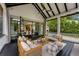 Relaxing outdoor living space with cozy seating, ceiling fan, and seamless transition to indoor dining area at 3773 Randall Se Rd, Atlanta, GA 30339
