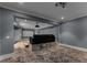 Modern home theater room with projector, screen, recessed lighting, and comfortable seating platform at 3773 Randall Se Rd, Atlanta, GA 30339