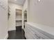 Walk-in closet with custom shelving and dark wood floors at 3773 Randall Se Rd, Atlanta, GA 30339