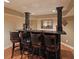 Basement wet bar with a black granite countertop and seating for four at 5617 Asheforde Ln, Marietta, GA 30068