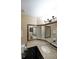 Bathroom with granite countertop, dark wood cabinet, and a three way mirror at 5617 Asheforde Ln, Marietta, GA 30068