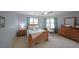 Cozy bedroom featuring a wood bed frame, natural light, and a dedicated desk area at 5617 Asheforde Ln, Marietta, GA 30068