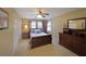 Comfortable bedroom with light-colored walls, ceiling fan, and wood furnishings at 5617 Asheforde Ln, Marietta, GA 30068