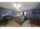 Sports-themed bedroom with desk, baseball bat decor, and blue walls at 5617 Asheforde Ln, Marietta, GA 30068