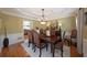 Formal dining room with crown molding, hardwood floors, and a large table perfect for entertaining at 5617 Asheforde Ln, Marietta, GA 30068