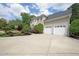 Exterior angle features a 3 car garage and large drive of a luxury home at 5617 Asheforde Ln, Marietta, GA 30068