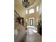 Bright foyer with high ceilings, chandelier, staircase, and tiled floors creating a grand entrance at 5617 Asheforde Ln, Marietta, GA 30068