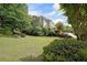 Beautifully landscaped front yard with mature trees and lush greenery at 5617 Asheforde Ln, Marietta, GA 30068