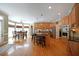 Open kitchen with granite counters, wood cabinets, stainless appliances, island with bar seating and adjacent dining area at 5617 Asheforde Ln, Marietta, GA 30068