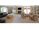Spacious living room with fireplace, built-in shelving, and large windows offering ample natural light at 5617 Asheforde Ln, Marietta, GA 30068
