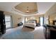 Relaxing main bedroom suite with tray ceilings, neutral tones, and comfortable sleeping area at 5617 Asheforde Ln, Marietta, GA 30068