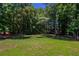 Large, private backyard surrounded by mature trees, perfect for outdoor activities and relaxation at 1406 Windy Ridge Se Ct, Conyers, GA 30013