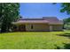 Expansive backyard with a covered porch, showcasing the home's exterior and outdoor living space at 1406 Windy Ridge Se Ct, Conyers, GA 30013
