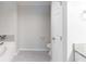 Bathroom features tile floors, white toilet, and tub with tile accents at 1406 Windy Ridge Se Ct, Conyers, GA 30013