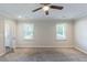 Spacious bedroom with a ceiling fan, neutral carpet, and a bright, airy feel at 1406 Windy Ridge Se Ct, Conyers, GA 30013