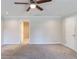 This bedroom features neutral walls, ceiling fan, carpeted floors, and natural light at 1406 Windy Ridge Se Ct, Conyers, GA 30013