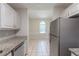 Bright kitchen features granite countertops, white cabinets, and stainless-steel appliances at 1406 Windy Ridge Se Ct, Conyers, GA 30013