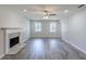 Spacious living room featuring hardwood floors, fireplace and large windows at 1406 Windy Ridge Se Ct, Conyers, GA 30013