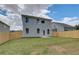 Backyard featuring a privacy fence, lawn and view of the home's exterior at 19 Camellia Dr, Fairburn, GA 30213