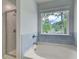 Bathroom with a corner tub, shower, and large window at 19 Camellia Dr, Fairburn, GA 30213