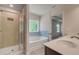 Bright bathroom with a shower, tub, double sink, and wood-look flooring at 19 Camellia Dr, Fairburn, GA 30213