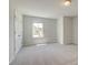 Cozy bedroom featuring neutral paint, a window, and carpet at 19 Camellia Dr, Fairburn, GA 30213