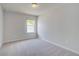 Neutral bedroom featuring carpet, window, and a closet at 19 Camellia Dr, Fairburn, GA 30213