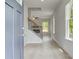 Inviting entryway with light wood floors, a staircase with black iron railings, and abundant natural light at 19 Camellia Dr, Fairburn, GA 30213