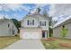 Charming home featuring a brick-accented garage, light-gray siding, and a welcoming front lawn at 19 Camellia Dr, Fairburn, GA 30213