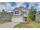 Charming two-story home with a brick-accented garage and neatly landscaped front yard at 19 Camellia Dr, Fairburn, GA 30213