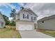 A charming two-story home with a light brick-accented garage and neatly landscaped front lawn at 19 Camellia Dr, Fairburn, GA 30213