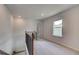 Upstairs hallway landing with carpet, neutral paint and trim at 19 Camellia Dr, Fairburn, GA 30213