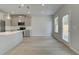 Bright kitchen with stainless appliances, pendant lighting, and hardwood floors leads to dining area at 19 Camellia Dr, Fairburn, GA 30213