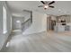 Spacious open-concept living area seamlessly connected to the kitchen and a staircase at 19 Camellia Dr, Fairburn, GA 30213