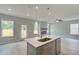 Open-concept living and kitchen area with stainless appliances, island, and lots of natural light at 19 Camellia Dr, Fairburn, GA 30213