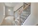 Bright staircase with light wood floors and black iron railings leading to the upper level at 19 Camellia Dr, Fairburn, GA 30213