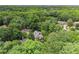 Aerial view of the home surrounded by lush trees and landscaping at 311 Rolling Rock Se Rd, Marietta, GA 30067
