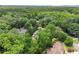 An aerial of a house with a canopy of mature trees in a picturesque neighborhood at 311 Rolling Rock Se Rd, Marietta, GA 30067