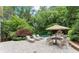 Lush backyard with a pool, patio, seating area, and mature landscaping at 311 Rolling Rock Se Rd, Marietta, GA 30067