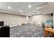 Finished basement with play and sitting area with neutral walls and patterned carpet at 311 Rolling Rock Se Rd, Marietta, GA 30067