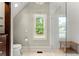 Bright bathroom featuring a glass shower and a window with a scenic view at 311 Rolling Rock Se Rd, Marietta, GA 30067