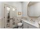 Stylish powder room features a framed mirror, sink, and commode with charming animal print wallpaper at 311 Rolling Rock Se Rd, Marietta, GA 30067