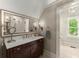 Elegant bathroom vanity with decorative lighting and a large mirror at 311 Rolling Rock Se Rd, Marietta, GA 30067