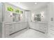Bright bathroom offers marble floors, dual sinks, and ample storage at 311 Rolling Rock Se Rd, Marietta, GA 30067