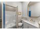 Stylish powder room features a walk-in shower, framed mirror, sink, and commode with charming animal print wallpaper at 311 Rolling Rock Se Rd, Marietta, GA 30067