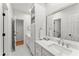 White bathroom featuring double sinks and black hardware at 311 Rolling Rock Se Rd, Marietta, GA 30067